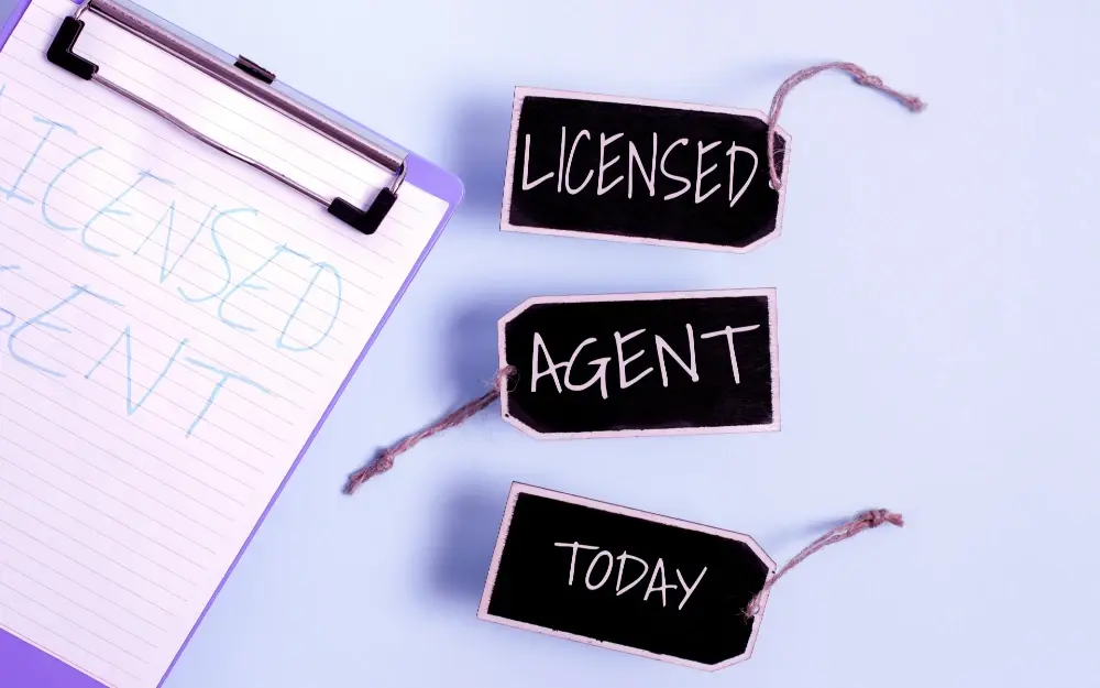 An image showing a clipboard with a paper of the left and 3 tags with the words licensed, agent, and today on white background.